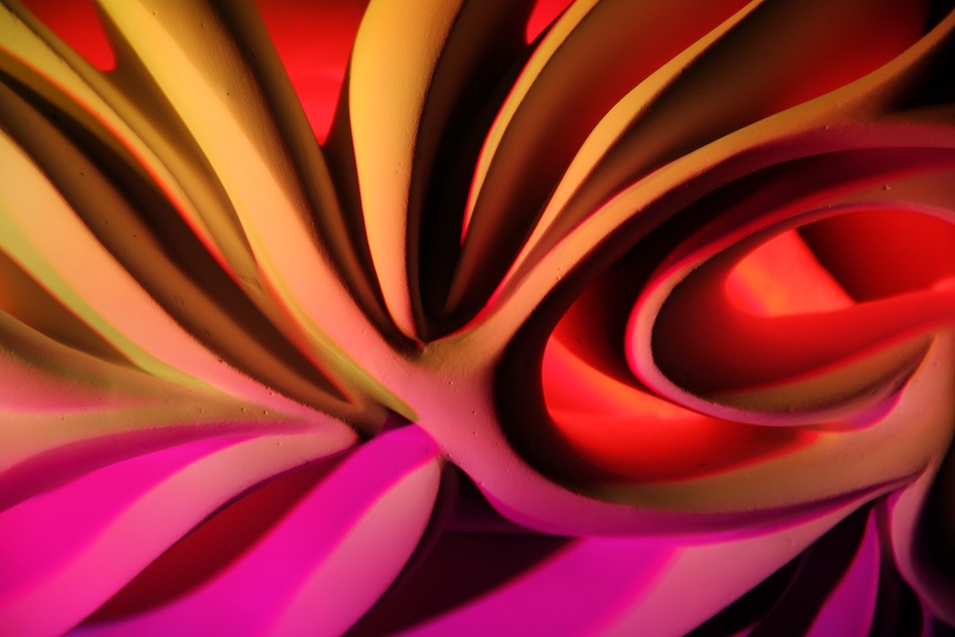Abstract sculpture with flowing magenta, orange, and deep red light.